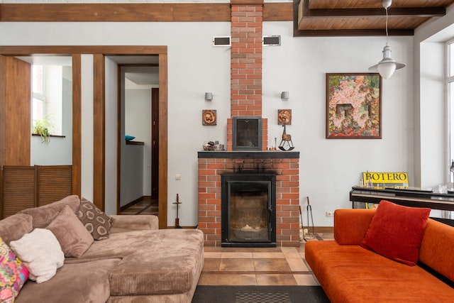  a brick fireplace near a sofa in a living room